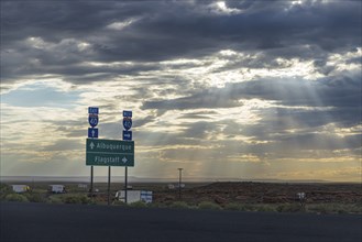 US Interstate I-40 road sign in Arizona with sunrays slicing through the clouds