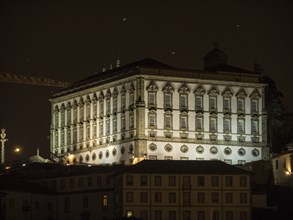 A historic building shines majestically in bright lights at night, Porto, Douro, Portugal, Europe