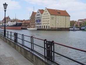 Riverside with historic buildings, ships and lanterns. Quiet atmosphere in a city with maritime