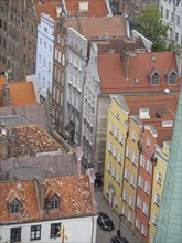 View of colourful house facades and narrow alleys in an old town with tiled roofs, Gdansk, Poland,