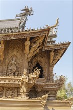 Detailed carvings and figures on a part of the wooden temple, artistically decorated, Pattaya,