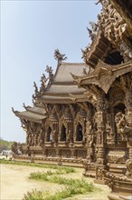 Detailed view of an ornate wooden temple, light and shadow effects on the structure, Pattaya,