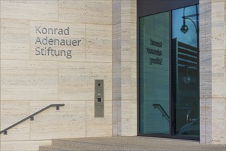 The lettering of the Konrad Adenauer Foundation reflecting in the window