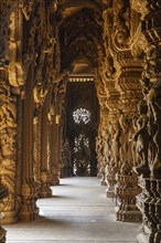 Interior view of a detailed carved wooden temple with ornate corridors, Pattaya, Thailand, Asia