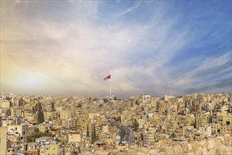 Jordan flag in Amman, panorama view of cloudy sky