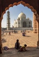 December 27th, 2016, Agra, India: Woman with her kid sitting in front of the Taj Mahal