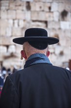 Religious orthodox jew from behind at the Western Wall in the old city of Jerusalem Israel