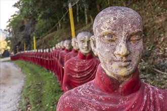 Long row of monk statues at Kaw Ka Thaung cave