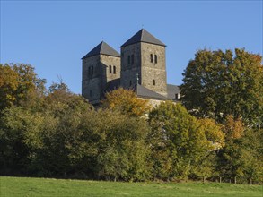 Castle with two towers, embedded in autumnal forest and illuminated by sunlight, nottuln,