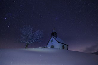 Night sky over church in Winter