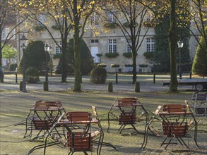 Square with abandoned seats in autumn sunlight, nottuln, münsterland, germany