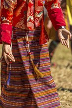 Dancer in traditional colorful clothing at a tshechu festival in Bhutan