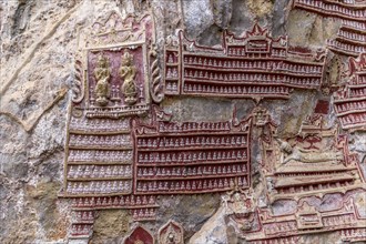 Hundreds of tiny Buddha Statues on limestone rock