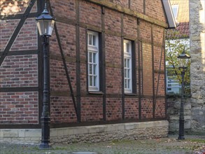 Half-timbered house with lanterns and windows in autumn, on cobblestones, nottuln, münsterland,
