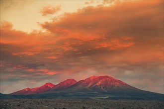 Intense sunset in the Atacam desert, mountains reflecting the sunlight