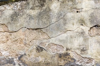 Grunge wall with fissures and plaster peeling of