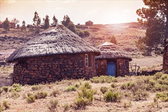 Huts with blue door in Sunset Lesotho