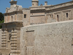 Section of a historic fortress with detailed stone architecture, mdina, mediterranean sea, Malta,