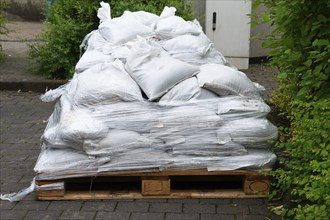 Sandbags for flood defense, river Moselle Trier in Rhineland Palatinate, flooded trees and paths,