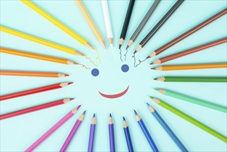Color pencils collection in a circle, back to school, drawing supplies, happy smiling face, blue