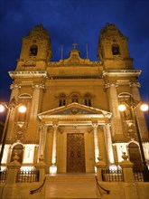 Historic church, warmly lit at night, marsaxlokk, mediterranean sea, malta