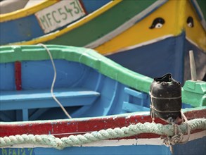 Detailed view of colourful boats docked at the harbour, marsaxlokk, mediterranean sea, malta