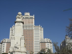City view with a monument and tall buildings under a blue sky, Madrid, Spain, Europe