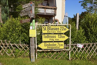 Old yellow signposts to St. Blasien, Bernau, Todtmoos, Präg and Gisiboden in the historic district