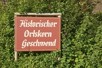 Old tourist information sign with the inscription Historic centre of Geschwend in the district of