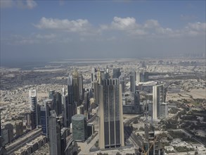 Far-reaching view of a modern city with numerous high-rise buildings and skyscrapers under a clear
