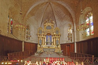 Interior view of the Gothic church Notre-Dame de Beauvoir high altar, candles, lights, church