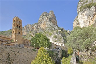 Church tower of Notre-Dame-de-l'Assomption and view to the rock, cliffs, summit, mountains,