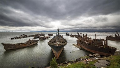 Abandoned and rusty shipwrecks in the sea under an overcast sky, atmosphere melancholic and gloomy,