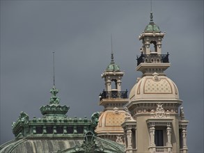 Detailed view of architectural towers and domes in front of a cloudy sky, monte carlo, monaco,