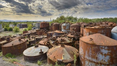 Rusty tanks in a junkyard under a partly cloudy sky, symbol photo, AI generated, AI generated