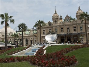 Prestigious palace with garden, fountain, palm trees and magnificent architecture, monte carlo,