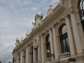 Historic magnificent facade of a building with detailed architectural elements and cloudy sky,