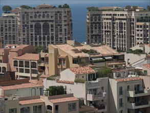 View of modern apartment building with Mediterranean architecture, sea in the background, monte