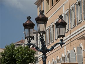 Traditional street lamp in front of classical buildings in a clear sky, monte carlo, monaco, france