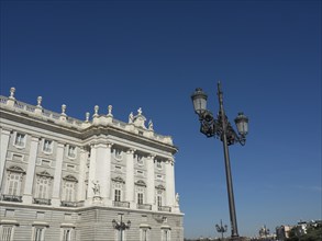 Magnificent wing and wrought-iron lanterns under a bright blue sky, Madrid, Spain, Europe