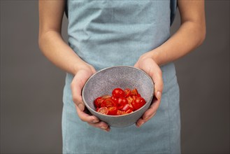 Tomato pieces in a bowl, prepare healthy food vegetables, holding fresh organic nutrition in the