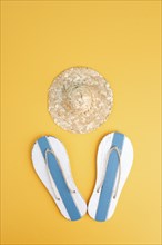 Summer vacation by the sea, flip flops and a straw hat, travel and tourism concept