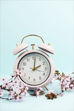 Alarm clock with cherry blossoms, switch to daylight saving time in spring, summer time changeover