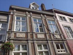 Historic house facade with windows and beams in sunny weather, Maastricht, limburg, netherlands