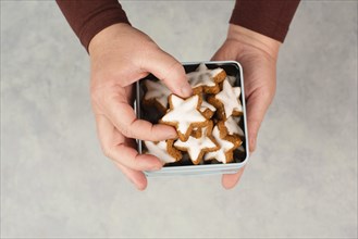 Cinnamon stars, Zimtsterne traditional german christmas cookies in a box, gingerbread with anise