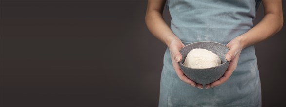 Fresh wheat dough, baker holds bowl with flour, bread or pizza, prepare ingredients for food,