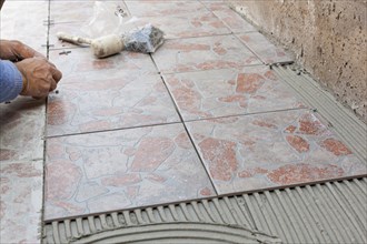 Tiler works with flooring in the backyard