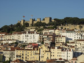 Cityscape with historical buildings, a castle on the hill and flags, Lisbon, portugal