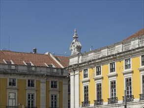 Clear image of historic buildings with yellow facades and blue sky, Lisbon, portugal