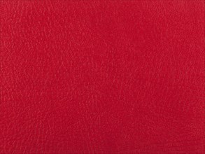Abstract texture of synthetic leather, red background